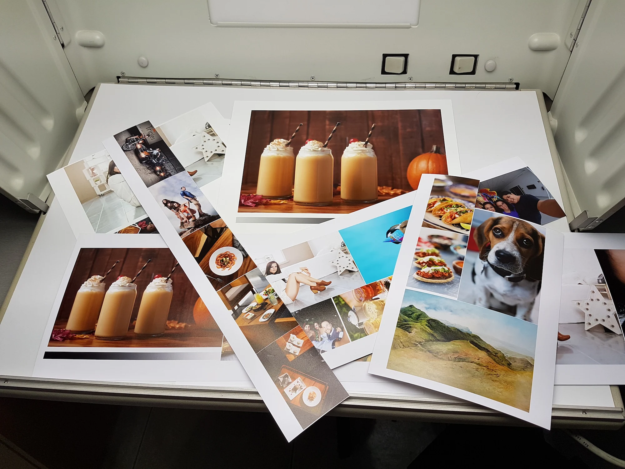 Mesa de trabajo con impresiones de prueba, referencias fotográficas y materiales del taller.